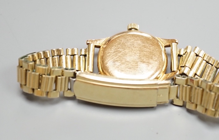 A lady's 18ct gold Omega manual wind wrist watch, on associated gilt bracelet, case diameter 23mm, with Omega guarantee pamphlet.